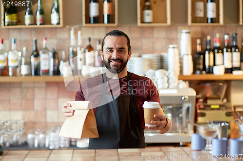 Image of man or waiter with coffee and paper bag at bar