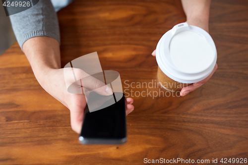 Image of close up of woman with smartphone and coffee