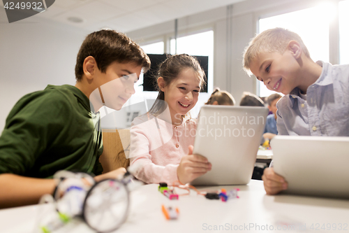 Image of kids with tablet pc programming at robotics school