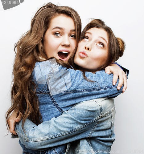 Image of best friends teenage girls together having fun, posing emotional on white background, besties happy smiling, lifestyle people concept close up