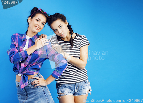 Image of best friends teenage school girls together having fun, posing emotional on blue background, besties happy smiling, lifestyle people concept 