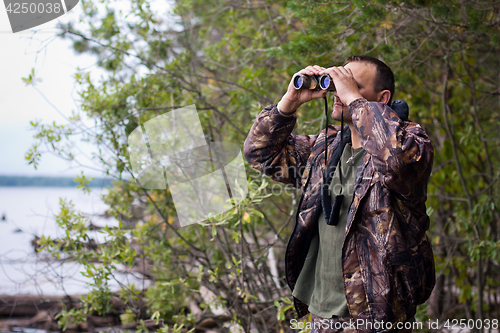 Image of Hunter looking through binoculars