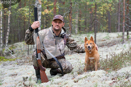 Image of hunter stroking his dog