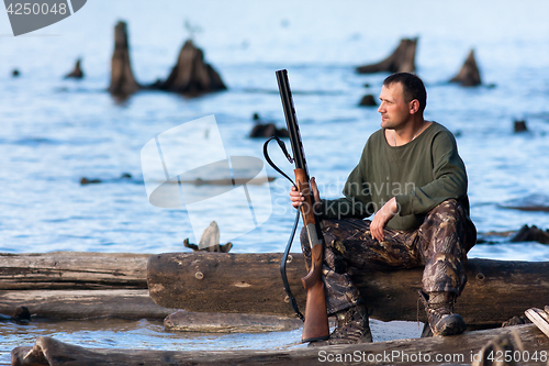 Image of hunter on the riverbank