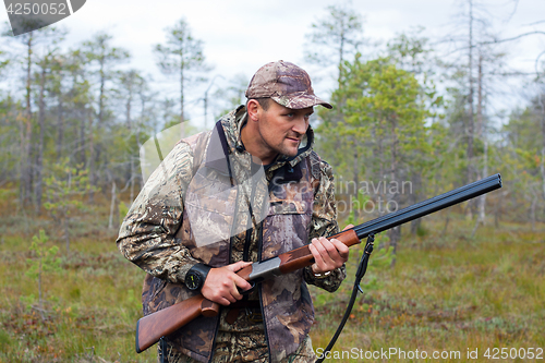 Image of hunter waiting for prey on the swamp