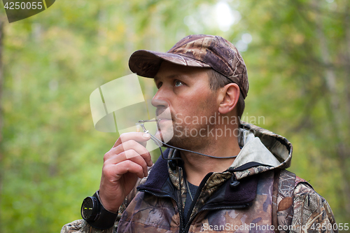 Image of hunter with a grouse call