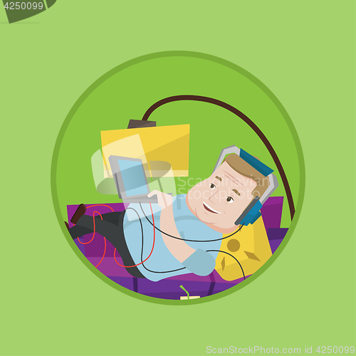 Image of Man lying on sofa with many gadgets.