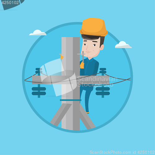 Image of Electrician working on electric power pole.