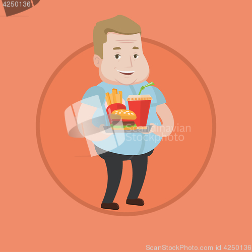 Image of Man holding tray full of fast food.