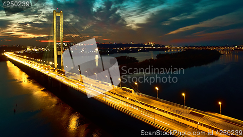 Image of Automobile and railroad bridge in Kiev, the capital of Ukraine. Bridge at sunset across the Dnieper River. Kiev bridge against the backdrop of a beautiful sunset in Kiev. Bridge in evening sunshine