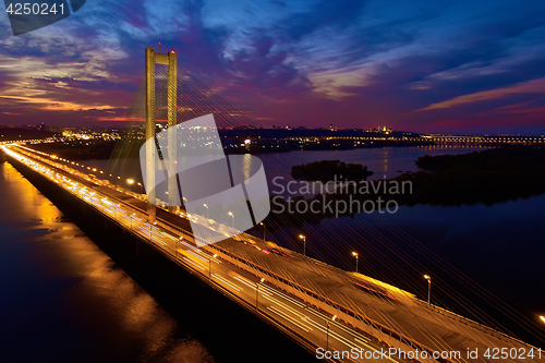 Image of Automobile and railroad bridge in Kiev, the capital of Ukraine. Bridge at sunset across the Dnieper River. Kiev bridge against the backdrop of a beautiful sunset in Kiev. Bridge in evening sunshine