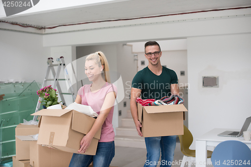 Image of young couple moving into a new home