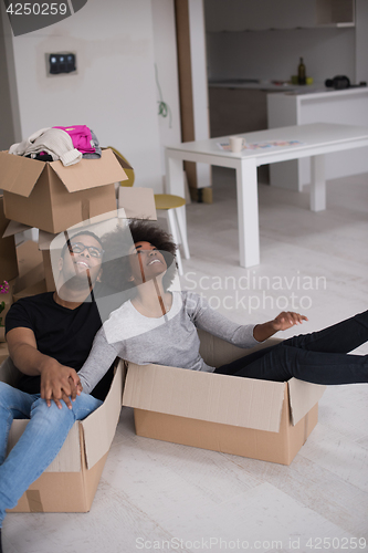 Image of African American couple  playing with packing material