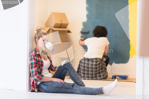 Image of young couple doing home renovations