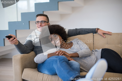 Image of multiethnic couple relaxing at home