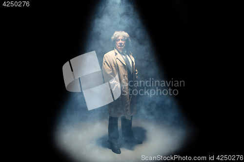 Image of The senior man as detective or boss of mafia on gray studio background