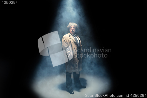 Image of The senior man as detective or boss of mafia on gray studio background