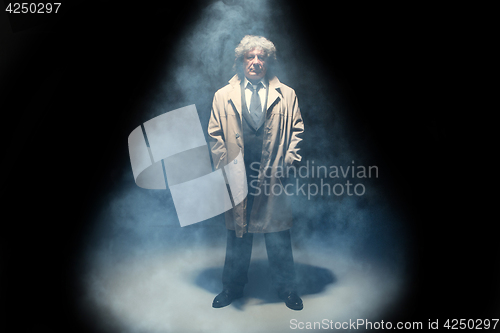 Image of The senior man as detective or boss of mafia on gray studio background