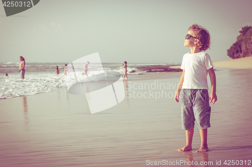 Image of Happy little boy playing on the beach 