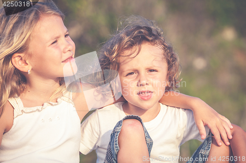 Image of Sister and brother playing on the beach at the day time.