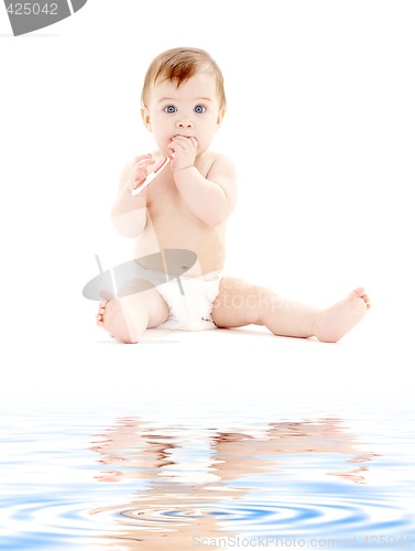 Image of baby boy in diaper with toothbrush