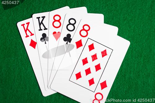 Image of poker hand of playing cards on green casino cloth