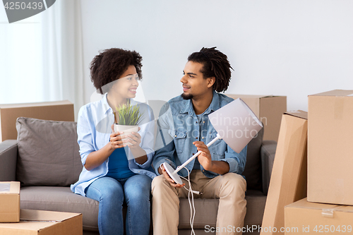 Image of happy couple with stuff moving to new home