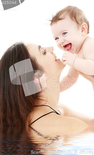 Image of laughing blue-eyed baby playing with mom