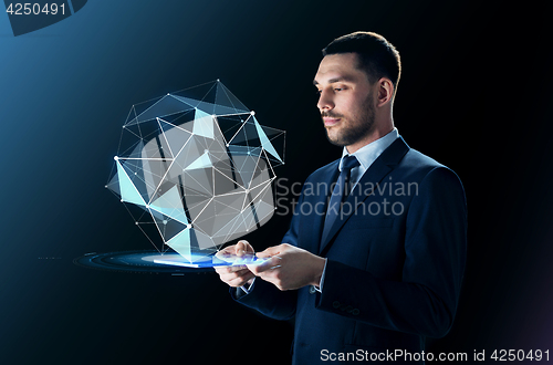 Image of businessman in suit with transparent tablet pc