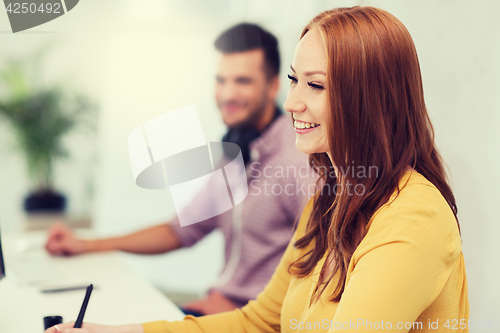 Image of happy creative team or students working at office