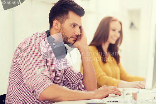 Image of creative team with headphones and computer