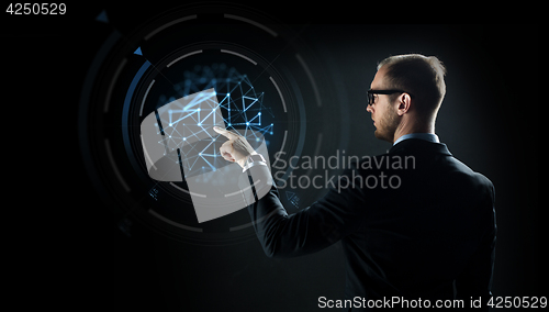 Image of businessman pointing finger to virtual projection