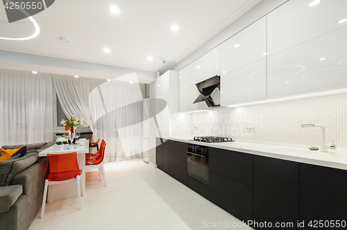 Image of Modern white kitchen and dining room