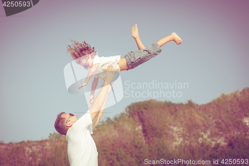 Image of Father and son playing on the beach at the day time.