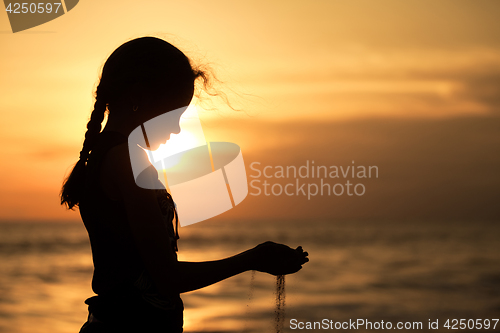 Image of Portrait of sad teenager girl standing on the beach