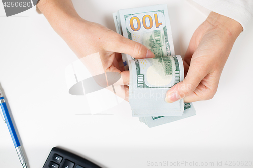 Image of Female hands counting money,