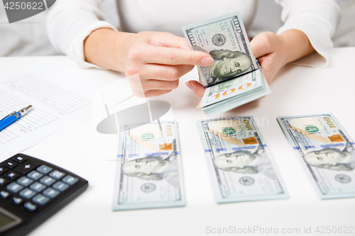 Image of Hands counting money, close up