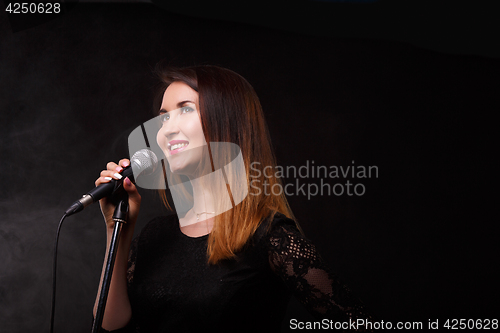 Image of Singer with microphone in studio