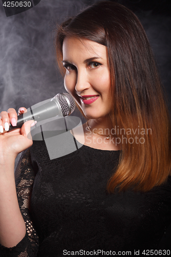 Image of Singer in dress with microphone