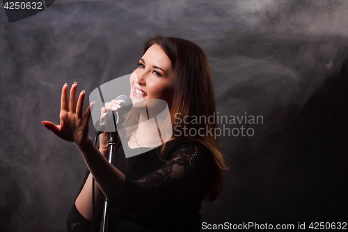 Image of Singing girl on smoke background