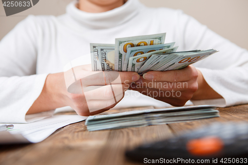 Image of Hands counting money, close up