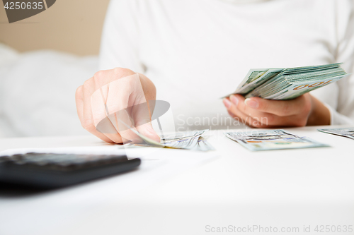 Image of Hands counting money, close up