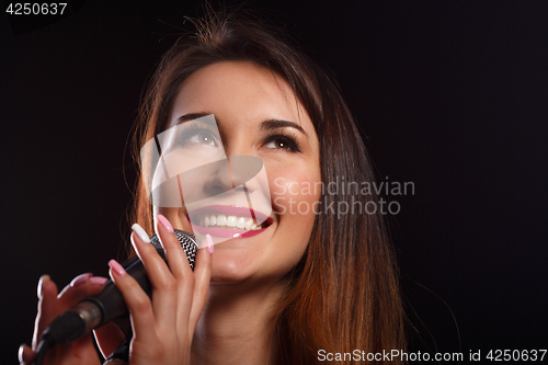 Image of Smiling brunette on black background