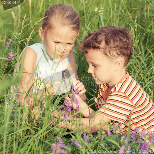 Image of Two happy children  playing in park