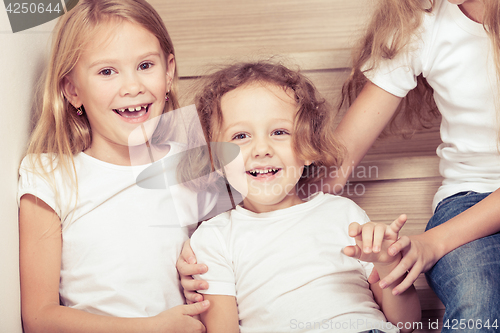 Image of Portrait of happy children which are sitting on the stairs in th