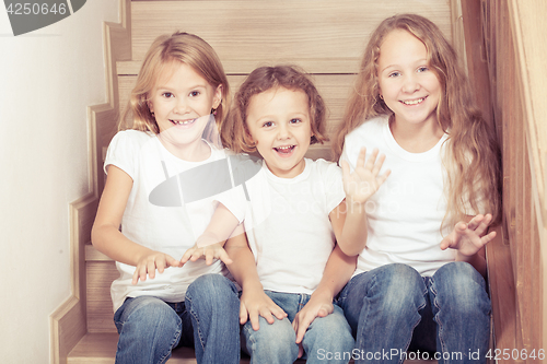 Image of Portrait of happy children which are sitting on the stairs in th