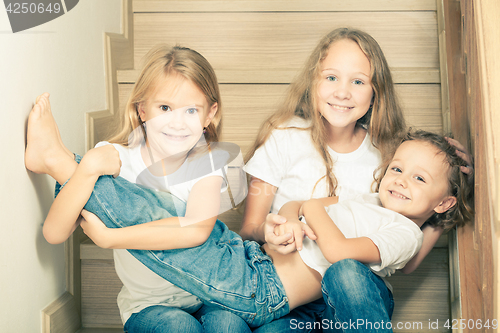 Image of Portrait of happy children which are sitting on the stairs in th