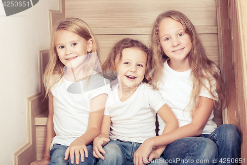 Image of Portrait of happy children which are sitting on the stairs in th