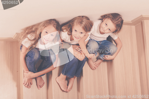 Image of Portrait of happy children which are sitting on the stairs in th