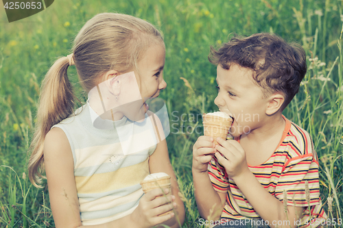 Image of Three happy children  playing in park